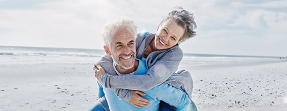 Casal na praia sorridente com a aplicação das mais-valias no BPI Casa 65.